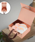 Dope Space Saving Foldable Gift Box For Clothes And Shoes With Adhesive Sticker open and filled with shoes on a wooden table.