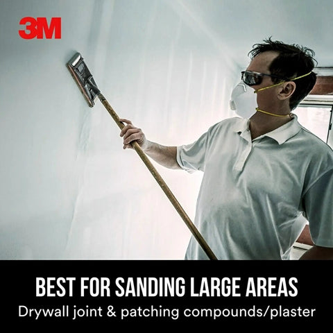 Person using a sanding tool on drywall with Pro-Pak Drywall Sanding Paper, 25 Sheets, 120 Grit, 4.2 Inch By 11.25 Inch in action