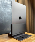 Dead Simple Vertical Thunderbolt 4 MacBook Docking Station Driving Two 4K Displays At 60Hz With Twelve Rock Solid Ports And Hella Fast 96 Watt Charging Plus Magsafe positioned vertically on a wooden desk.