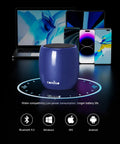 Navy blue Tiny But Mighty Bluetooth Speaker With 360 Degree HD Stereo Sound And Punchy Bass, surrounded by devices