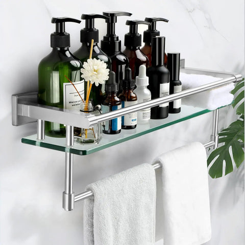 Brushed Nickel 20 Inch Glass Bathroom Shelf With Towel Bar displayed with toiletries, mounted on wall with white towels hanging below