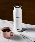 Travel Stainless Steel Electric Kettle 450ml With Temperature Control LED Auto Shutoff on marble countertop next to coffee cup