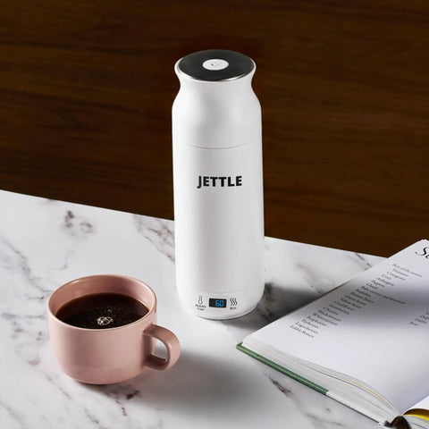 Travel Stainless Steel Electric Kettle 450ml With Temperature Control LED Auto Shutoff on marble countertop next to coffee cup