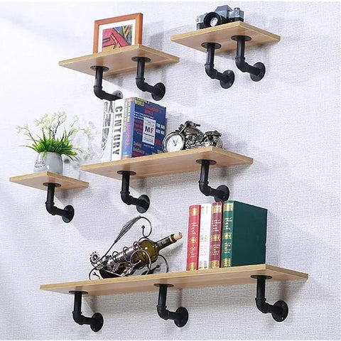Wall-mounted wooden shelves with Beefy Iron Pipe Shelf Brackets For 7 To 14 Inch Boards, L Style Floating Shelves, holding decor items.
