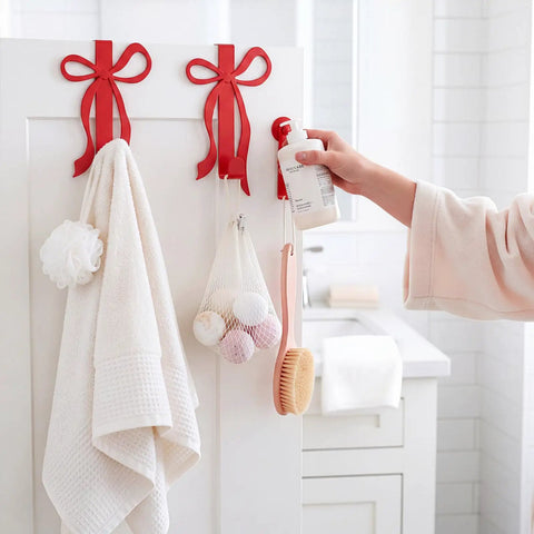 Sort Your Daily Grind Smoothly With These Heavy Duty Red Bow Over The Door Hooks Perfect For Dropping Coats Towels Hats And Bags While Keeping Main Room Coquette Vibes Strong. Image of hooks holding towels and bath items.