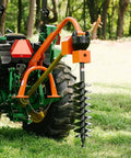 Beefy 60 HP 3 Point Post Hole Digger With 12 Inch Auger Attachment connected to a tractor on grass, rear-mounted view