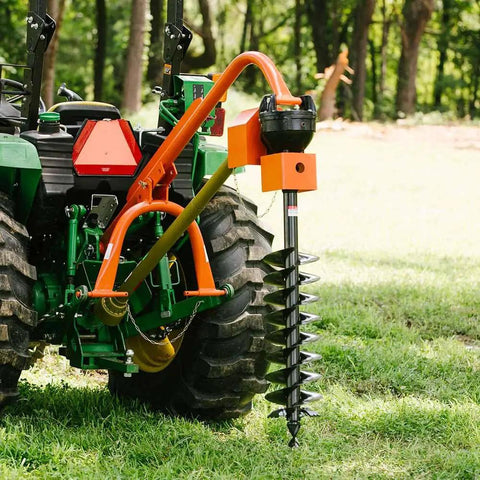 Beefy 60 HP 3 Point Post Hole Digger With 12 Inch Auger Attachment connected to a tractor on grass, rear-mounted view