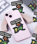 Three Piece Electricity Explained Sticker Set With Funny Volts Amps Ohms Quotes For Electrical Engineers Physics Teachers And STEM Students displayed with phone and keyboard