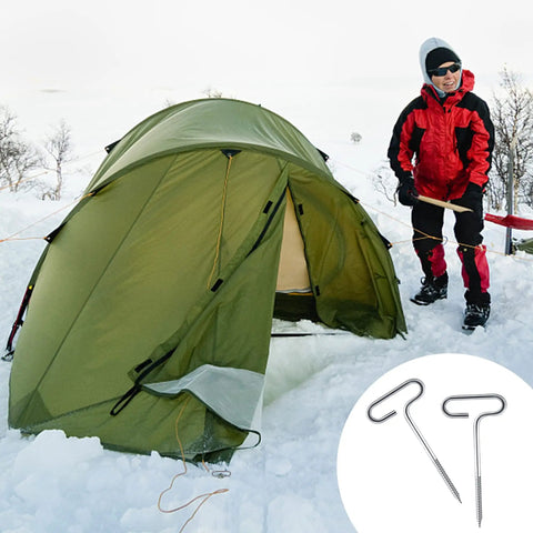 Ice Anchor Drill Adapter Kit With 4 Threaded Peg Stakes for securing a green tent on snow by a person in winter gear.