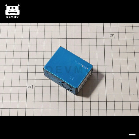 Digital Particle Concentration Sensor PMS5003 for Air Quality Monitoring in metal casing, Arduino compatible, top view on grid surface.
