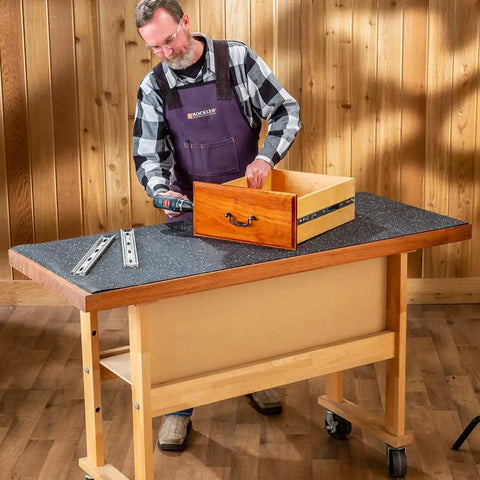 Man using Heavy Duty Rubber Workbench Mat 2x5 Feet for woodworking on tool bench with durable SBR and EPDM construction, grippy surface.