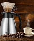 Built Tough 34 Oz Thermal Coffee Carafe With Double Wall Stainless Steel Vacuum Insulation Keeps Your Daily Brew Piping Hot And A Totally Sweat Proof Build Handles Any Commute Or Living Room Setup Smooth Pour Spout Silver with coffee and beans.