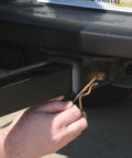 Hands installing Trailer Hitch Umbrella Mount For Easy Tailgate Shade On The Go No Fuss Quick Install With Slide In Square Receiver
