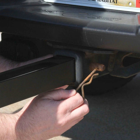 Hands installing Trailer Hitch Umbrella Mount For Easy Tailgate Shade On The Go No Fuss Quick Install With Slide In Square Receiver