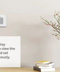 Non Programmable Thermostat With Backlit Display And No Fuss Simple Manual Controls on wall, white finish, home setting.