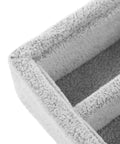 Close-up view of gray velvet jewelry organizer tray with elastic grid for rings earrings necklaces watches glasses.