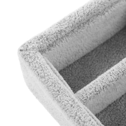 Close-up view of gray velvet jewelry organizer tray with elastic grid for rings earrings necklaces watches glasses.
