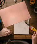 Single Sided Copper Clad PCB Laminate 1.4mm Thick Copper Plated Universal Circuit Board For Etching And DIY Prototyping Kit 20x30cm And 11.8x7.8 Inches For Easy Soldering And Circuit Projects on a workbench with tools