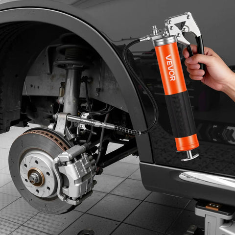 Heavy Duty 8000 PSI Grease Gun Kit with Pistol Grip, 14 oz capacity, connected to automotive brake system