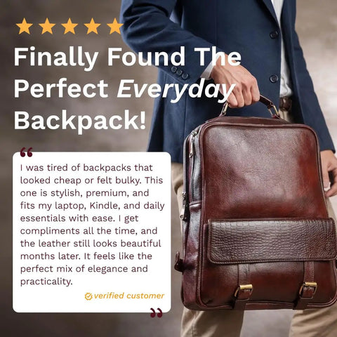 Person holding Genuine Burgundy Leather Laptop Backpack For Work And Travel On The Go, 15.6 Inch Pro Grade Office Bag, in front of body.