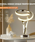 Modern Spiral RGB Table Lamp With Touch Dimmable LED, Ten Light Modes, on a nightstand, unique trophy shape for home decor.