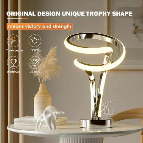 Modern Spiral RGB Table Lamp With Touch Dimmable LED, Ten Light Modes, on a nightstand, unique trophy shape for home decor.