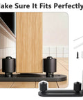 Four Pack Black Sliding Barn Door Floor Guides Flush Wall Mount Bottom Adjustable Rollers Flat Non Scratch Barn Door Hardware Kit With Two Assembly Options Heavy Duty installed view next to door with tools.