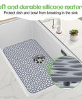 Heat Resistant Silicone Sink Protector Mat With No Slip Grid Design For Kitchen Sinks, Rear Drain Access, Durable Silicone Mat, 26.4 Inch By 14.4 Inch, Easy Cleanup, Keeps Counter Dry in a white sink