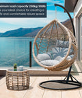 Rattan hanging chair with cushions on patio overlooking a lake, suitable for creating a comfortable leisure space.