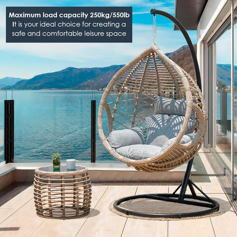 Rattan hanging chair with cushions on patio overlooking a lake, suitable for creating a comfortable leisure space.