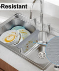 Double Sink Mat Protector With 36 Suction Cups No Odor No Stains Super Soft Divider Pad Shields The Center Of A Double Sink While You Wash Dishes Kitchen Accessory 12.83 By 11.1 Inches in use on a kitchen sink with dishes.