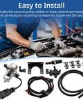 Installed under-hood view of 12V brake booster vacuum pump kit with silver pump, black hoses, mounting hardware.