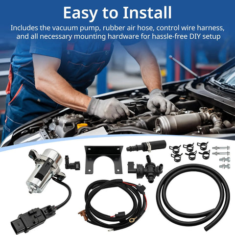 Installed under-hood view of 12V brake booster vacuum pump kit with silver pump, black hoses, mounting hardware.