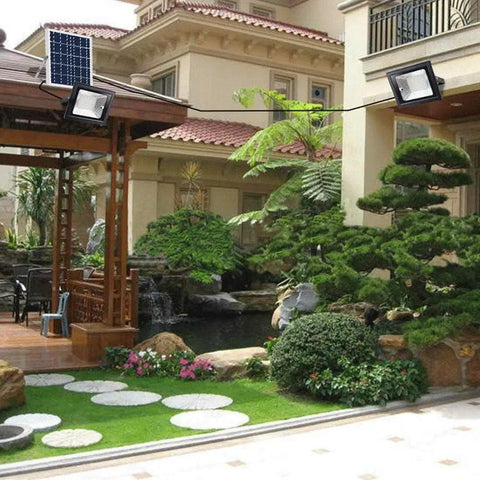 Solid Solar Flood Light With A Kickin Brightness Setup And Zero Sweat Weather Proofing For Your Patio Decks And Yard Upgrades Including Remote Controls And Hella Efficient Led Lighting illuminating a landscaped yard with a gazebo.