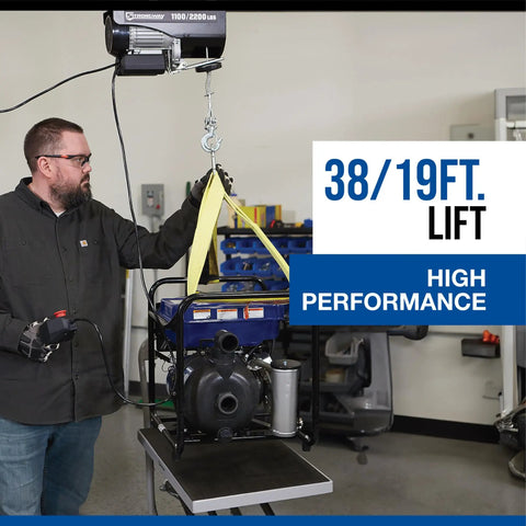Strongway 1100 Lb Electric Cable Hoist with 2200 Lb Double Line Capacity in garage lifting a unit with 38ft height.