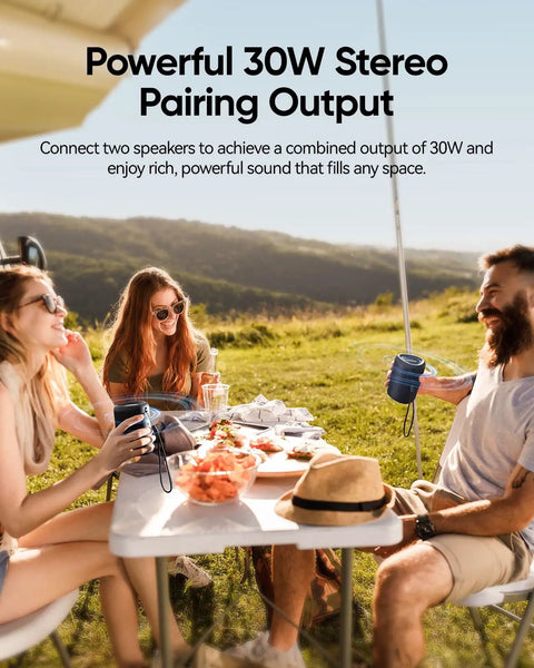 Friends enjoying music with Beach Essentials Bluetooth Speaker With Crystal Clear Sound IPX5 Waterproof at outdoor picnic.