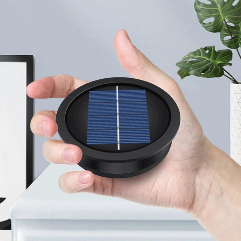 Hand holding Two Pack Solar Light Replacement Tops For Outdoor Hanging Lanterns with solar panel visible
