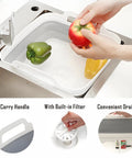 Collapsible Dish Basin With Drain Plug And Drainer 9L 2.4 Gallon Portable Wash Basin in use with vegetables in a kitchen sink.