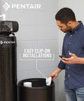 Person installing Smart Salt Level Sensor For Water Softening Systems Set And Forget With WiFi Or Bluetooth Alerts Universal Tank Clip