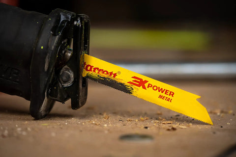 Close-up of bi-metal reciprocating blade attached to saw, demonstrating durable weld-enhanced design for long life