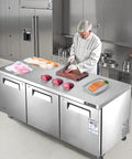 Tough 72 Inch Wide Commercial Undercounter Freezer With Triple Locking Doors And Smooth Rolling Casters, 17 Point 7 Cu Ft Stainless Steel Prep Worktable used in a restaurant kitchen.