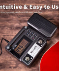 GE100 Multi Effects Guitar Pedal With 80 Presets And 66 Effects Built In Looper on wooden surface with guitar in view.