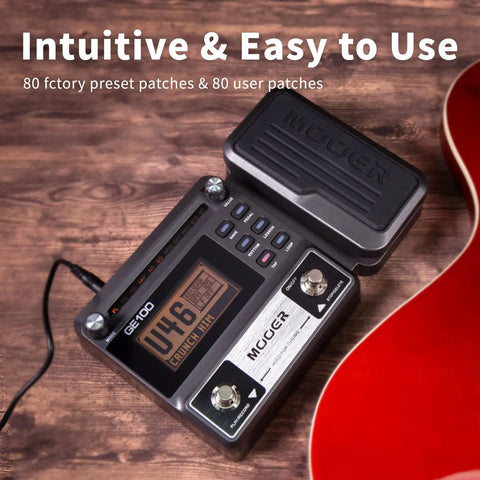 GE100 Multi Effects Guitar Pedal With 80 Presets And 66 Effects Built In Looper on wooden surface with guitar in view.
