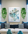Three Pack Artificial Hanging Plants Ivy Vines, About Three Point Six Feet Total Length, in living room beside artwork