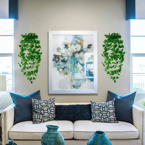 Three Pack Artificial Hanging Plants Ivy Vines, About Three Point Six Feet Total Length, in living room beside artwork