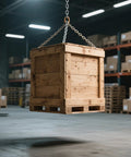 Wooden crate suspended in a warehouse setting using a chain hoist.