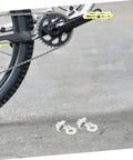 Adjustable Aluminum Alloy Bike Chain Tensioner Tool 2 Piece Set For Folding Bikes displayed near bike crank and chain.
