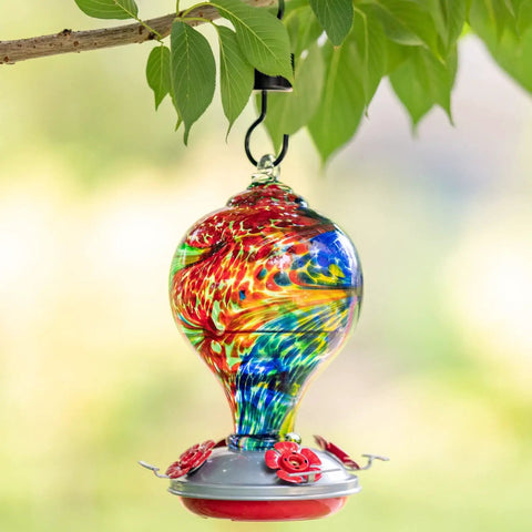 Nebula Color Hummingbird Feeder With Ant Moat And 32 Oz Nectar Capacity For Backyard Decor hanging on tree branch.