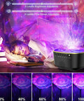 Lit Star Projector Galaxy Night Light with Remote and Timer projecting stars and ocean waves in a bedroom setting.