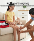 330 Piece First Aid Kit, red waterproof compact case opened with bandages; man applies a bandage to girl's knee.
